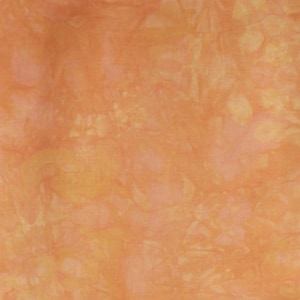 May include: A close-up of a fabric with a tie-dye pattern in shades of orange and yellow.
