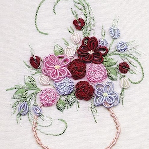 May include: Embroidered floral bouquet in shades of pink, purple, and red, with green leaves and stems, arranged in a pink embroidered vase.
