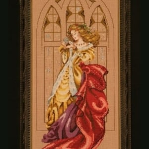 May include: A woman in a gold and purple dress with a red cloak stands in front of a stained glass window. She is holding a small bird in her hand. The window is decorated with a snowflake design.