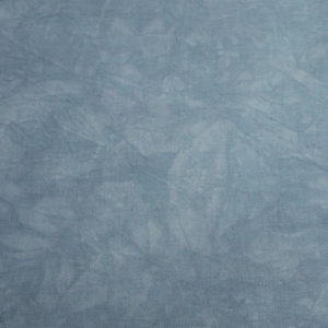 May include: A close-up of a light blue fabric with a subtle, mottled pattern. The fabric has a soft, textured surface.