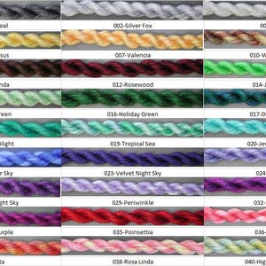 May include: A color chart of 20 different colors of embroidery floss. The floss is arranged in rows of three, with each color labeled with a number and a name. The colors include charcoal, silver fox, vanilla, narcissus, valencia, winter woods, jacaranda, rosewood, jewel green, mint green, holiday green, deep blue sea, teal twilight, tropical sea, summer sky, velvet night sky, purple night sky, berry purple, fiesta, periwinkle, poinsettia, jewel turquoise, blueberry, ultra violet, valentines, rosa linda, and highland meadow.