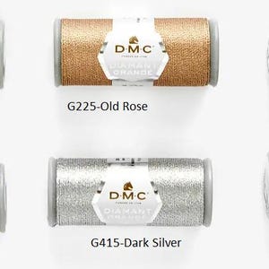 May include: Six spools of DMC Diamant embroidery thread in various metallic colors: anthracite grey, dark gold, old rose, dark silver, light gold, and light silver.