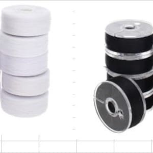 May include: A collection of sewing machine bobbins arranged in two groups. One group consists of white thread wound onto clear plastic bobbins, while the other group features black thread wound onto clear plastic bobbins, stacked in vertical columns.
