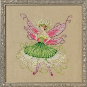 May include: A cross-stitch embroidery of a fairy with pink wings and a green dress. The fairy is surrounded by white flowers and green leaves.
