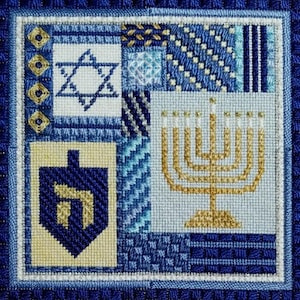May include: A blue and gold cross-stitch sampler featuring a Star of David, a menorah, and a dreidel. The design is made up of various geometric patterns and is framed in a blue border.