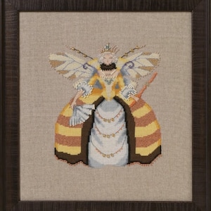May include: A cross-stitch embroidery of a fairy queen wearing a yellow and brown striped dress with a crown and wings. The fairy is holding a wand in her hand.