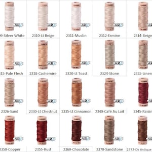 May include: A collection of 15 spools of thread in various colors, including beige, brown, red, and white. Each spool is labeled with a number and a color name.
