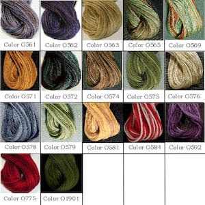May include: A collection of embroidery floss spools in various colors, including blue, green, red, purple, and yellow. Each spool is labeled with a color number.