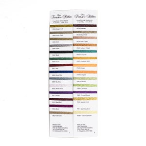 May include: A color chart for Treasure Ribbon embroidery floss. The chart shows 25 different colors of floss, with the color name and floss code listed next to each color. The chart is made in the USA and is hand washable.