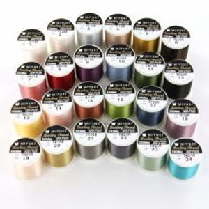 May include: A collection of twenty-four spools of Miyuki beading thread arranged in a grid. Each spool features a white label with the brand name, product details, and a unique color number. The threads display a variety of solid colors.