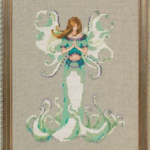 May include: A cross stitch pattern featuring a green and white fairy with wings and a flowing gown. The fairy is holding her hands together in a prayer position.