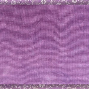 May include: A purple textured background with a white floral border.