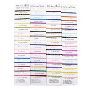 May include: A color chart of 128 different shades of Silk Lame Braid embroidery floss. The floss is arranged in rows of 16 colors each. The chart includes the floss number and name for each color. The floss is 72% silk, 18% rayon, and 10% metalized polyester. It is hand washable and distributed by Rainbow Gallery.