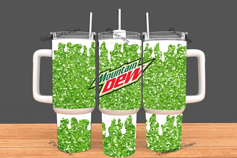 May include: A set of three insulated tumblers with white handles and lids. The tumblers feature a green glitter design with white drips and the Mountain Dew logo. Each tumbler has a white straw.