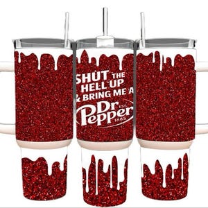 May include: A set of three red glitter travel mugs with white accents. The center mug features the text "SHUT THE HELL UP & BRING ME A Dr Pepper" in white. Each mug has a white handle and a straw.