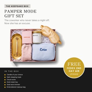The image is an advertisement for a gift set called "The Keepsake Box" that includes a pamper mode gift set for a coworker who never takes a night off. The gift set includes a sleeping mask, cotton socks, a gold metal tray, a gold wire tray, and an embroidered makeup bag.