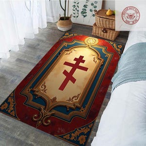 May include: Rectangular rug with a red and gold border, featuring a central design of a red cross on a cream background. The rug has a decorative, ornate frame with blue accents and floral patterns.