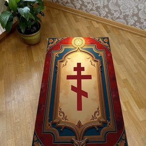 May include: A rectangular prayer rug with a red and gold Orthodox cross design. The rug has a red border with gold floral accents and a blue frame. The center features a cream-colored background with a red cross.