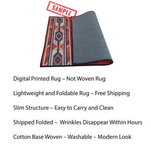May include: A digitally printed rug with a geometric pattern in red, blue, and orange. The rug is lightweight and foldable, with a slim structure. The rug has a cotton base and is washable.