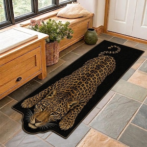 May include: A rectangular floor runner rug featuring a realistic, full-body leopard print design centered on a solid black background. The leopard is depicted in a prone, resting position with its head facing forward and tail extended behind it.