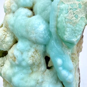 May include: A large, blue and white, geode specimen with a unique, bubbly texture. The geode is a natural formation with a variety of shapes and sizes.