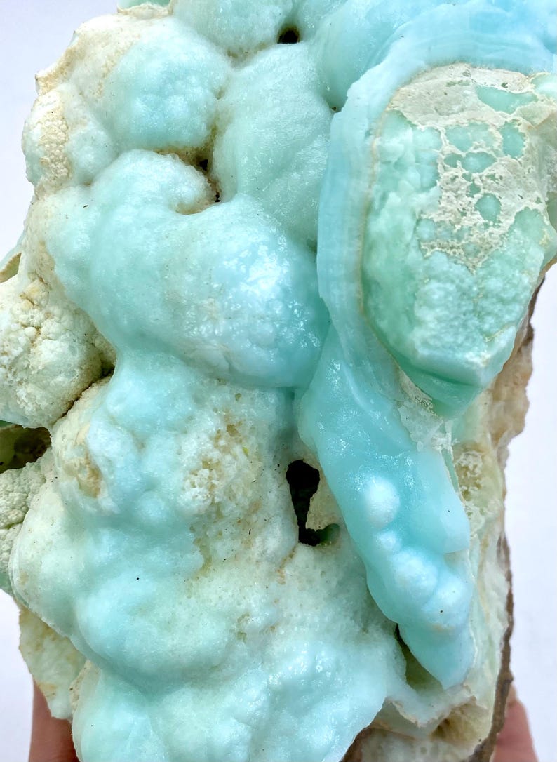May include: A large, blue and white, geode specimen with a unique, bubbly texture. The geode is a natural formation with a variety of shapes and sizes.