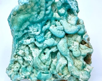 May include: A large, blue and white, naturally formed, geode with a rough, textured surface. The geode has a unique, organic shape and is filled with intricate, swirling patterns.