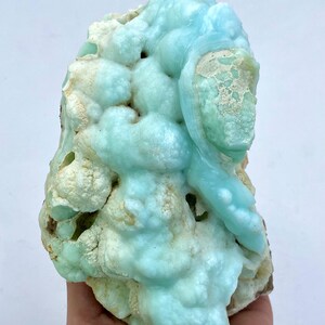 May include: A large, blue and white, geode specimen with a unique, bubbly texture. The geode is a natural formation with a variety of shapes and sizes.