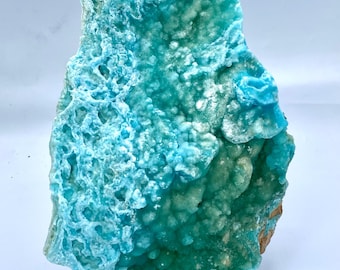May include: A large, irregularly shaped piece of blue and green mineral with a rough, textured surface. The mineral has a variety of shades of blue and green, and appears to be translucent.
