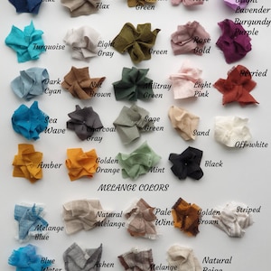May include: A chart of fabric swatches in various colors, including blue, green, brown, orange, pink, and white. The swatches are labeled with their corresponding color names. The chart also includes a section labeled "Melange Colors" with swatches of blended colors.