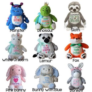 May include: A collection of nine plush stuffed animals, including a blue monster, green dinosaur, and gray sloth. Each animal has embroidered details and text, such as names and dates. The collection also includes a white unicorn, lemur, fox, pink bunny, blue bunny, and donkey.