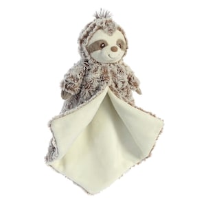 May include: A plush, brown and cream-colored sloth-shaped baby security blanket. The sloth has a smiling face, brown eyes, and a hood. The blanket is square with a soft, cream-colored interior. The overall design is soft and cuddly.