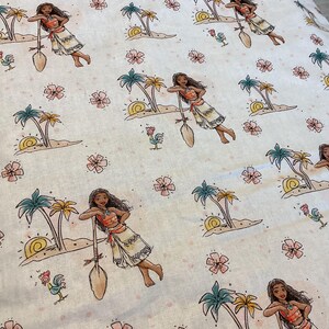 May include: White fabric with a repeating pattern of a cartoon character holding a paddle, palm trees, flowers, and roosters. The character is wearing a brown and orange outfit.