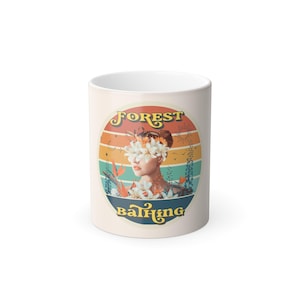 May include: A white ceramic mug with a circular design featuring a woman's portrait adorned with flowers. The design includes the words "FOREST" and "bathing" in a retro font, set against a backdrop of colorful stripes.