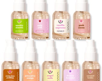 May include: A collection of ten dry body oil bottles with white pumps and colorful labels. Flavors include "sparkly matcha," "only you," "vanilla supreme," and "posh cocoa." The bottles are arranged in two rows.