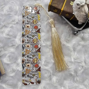 May include: A clear plastic bookmark with a Harry Potter theme. The bookmark features a repeating pattern of Harry Potter icons, including the Hogwarts crest, glasses, a lightning bolt, and the words "Always" and "9 3/4". The bookmark has a gold tassel.