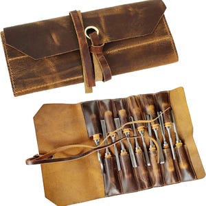 May include: A brown leather roll-up case with a strap and buckle closure. The case is open to reveal a set of 10 wood handled chisels with metal blades.