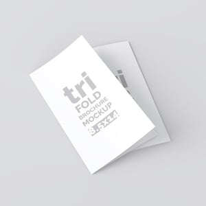 May include: A white trifold brochure mockup with the text "tri FOLD BROCHURE MOCKUP 8.5x11" in gray. The brochure is partially open, revealing the inside pages. The background is a solid light gray.