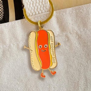 Hot Dog Keychain – Happy Hot Dog Enamel Charm for Bag, Purse or Backpack – Fun Gift for Foodie, Camper, Baseball Fan, BBQ Lover - Gold Metal
