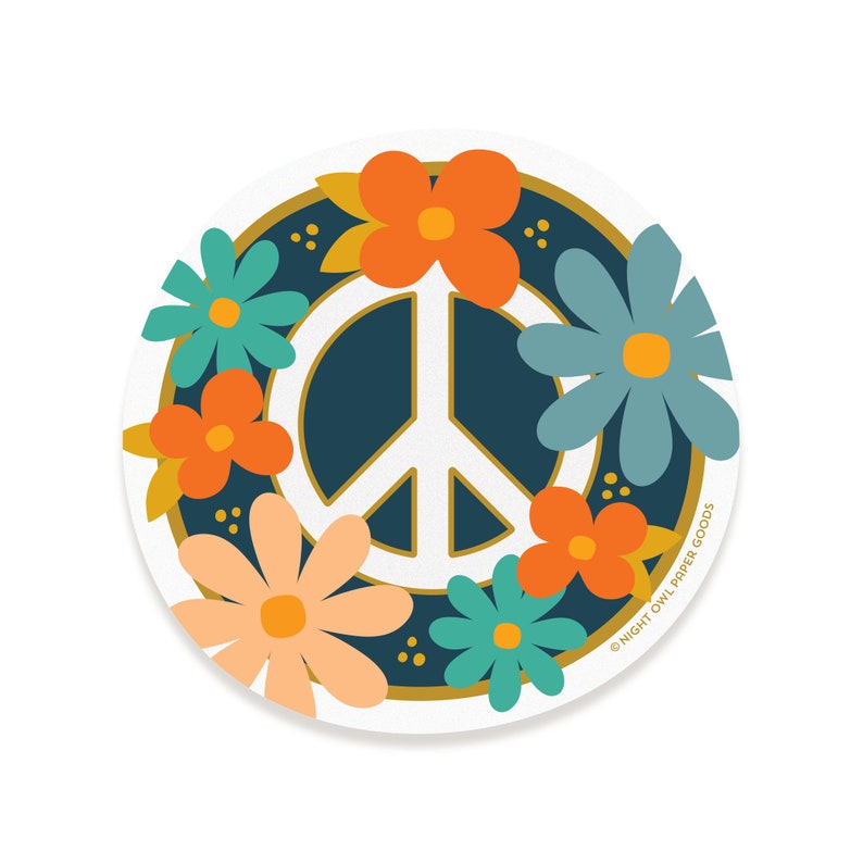 May include: A white peace sign surrounded by a wreath of colorful flowers in shades of orange, peach, blue, and green. The background is a dark blue color with gold accents. The text "NIGHT OWL PAPER GOODS" is in the lower right corner.