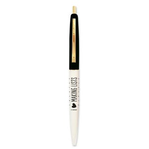 May include: A white pen with a black top and a gold accent. The pen has black polka dots and the text "I ♥ MAKING LISTS" printed on the side.
