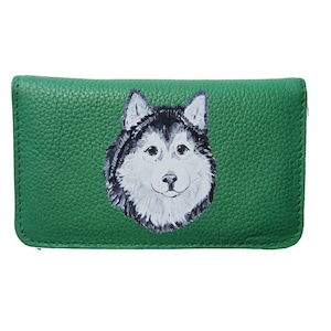 May include: A green leather wallet with a painted image of a husky dog's face.