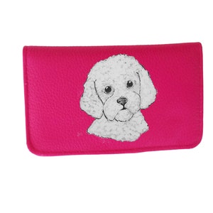 May include: A pink leather wallet with a white poodle illustration.