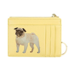 May include: A yellow cardholder with a zipper closure and a gold-colored key ring. The cardholder features a printed image of a pug dog. The cardholder has multiple card slots.
