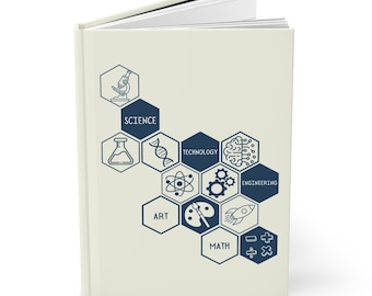 May include: A cream-coloured hardcover journal. The cover displays navy blue hexagonal shapes with science, technology, art, and math icons and text. The journal is open, showing white pages. The design is educational.