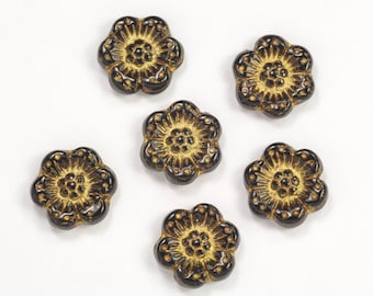 May include: Six black and gold flower-shaped buttons with a raised design.