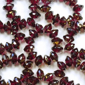 Cuentas de vidrio checo Saturno facetadas, color fucsia intenso, 9 x 6 mm, con platillo dorado - 12