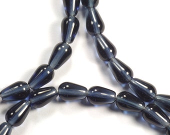 May include: A strand of dark blue glass beads in a teardrop shape.