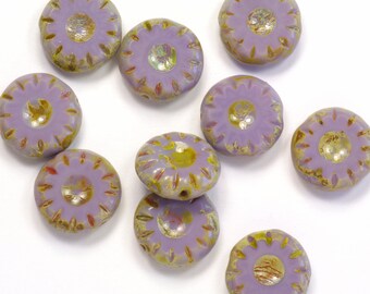 May include: Ten purple glass beads with a raised flower design and a gold flecked center. The beads are approximately 1 inch in diameter.
