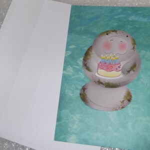 Manatee with blushing cheeks holding birthday cake Happy Birthday greeting card